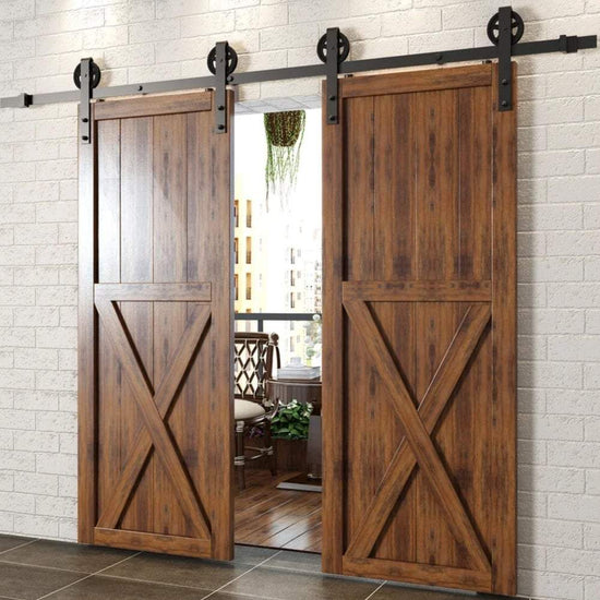 Rustic wooden sliding barn doors with black hardware in a contemporary interior setting