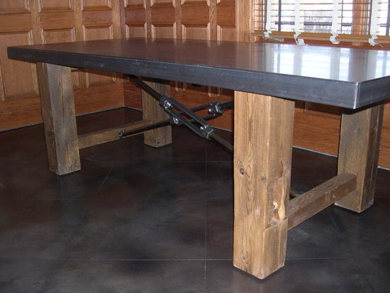 Rustic wooden table with a sleek metal top and functional threaded rod support