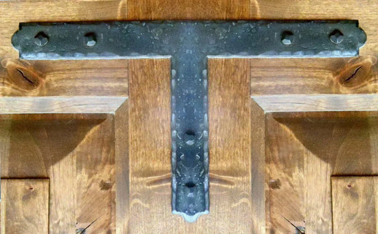 Black iron T plate mounted on rustic wooden surface, enhancing structural integrity and decor