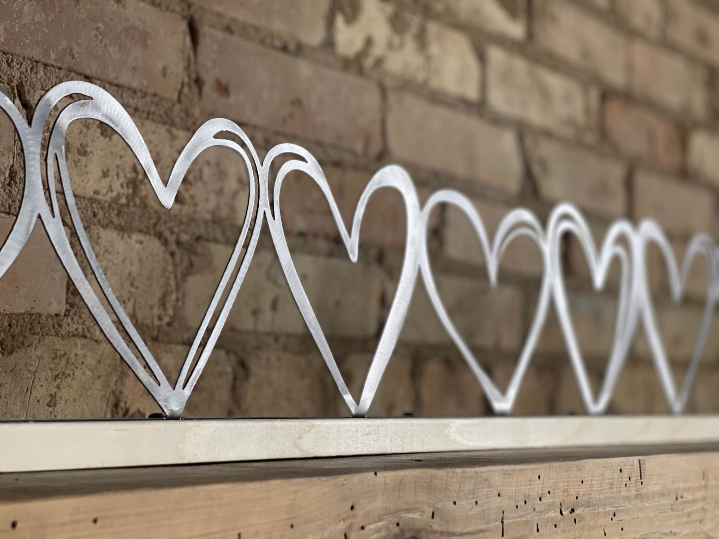 Row of Hearts on Wood Stand